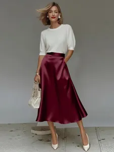 Elegant satin A-line midi skirt detail, smooth glossy fabric texture, stylish commute look.
