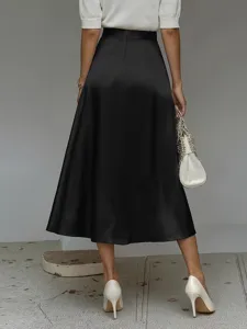 Detail view of women's elegant black satin A-line midi skirt worn with white top.