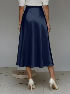 Back view detail of elegant navy blue satin A-line midi skirt paired with white heels.