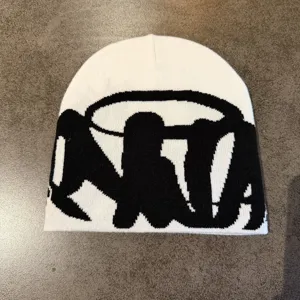 Unisex black and white knit beanie featuring bold street style letter jacquard pattern.