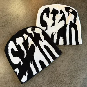 Close up view of the black and white knitted beanie with stylish star letters design.
