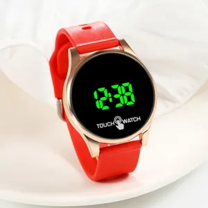 Round LED digital electronic watch with red silicone strap and rose gold case for daily wear.