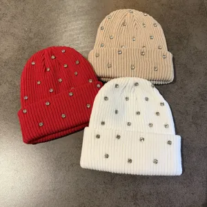 Women winter warm knitted beanie hat with sparkling rhinestones, stylish and cozy street style.