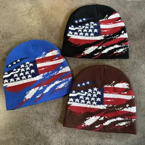 Close-up of knitted beanies featuring distressed US flag patterns, showing fine texture.