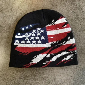 Detail view of the stylish black knitted beanie featuring a distressed American flag pattern.