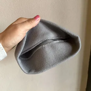 Grey knit beanie detail showing soft texture and cozy winter fabric construction and design