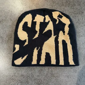 Black knit beanie hat with bold letter pattern, warm hip-hop streetwear winter cap for daily wear.