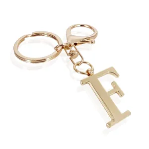 Gold metal letter F keychain with lobster clasp and split ring for bags and keys.