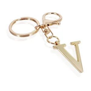Gold metal letter V keychain with ring and lobster clasp, stylish initial bag charm.