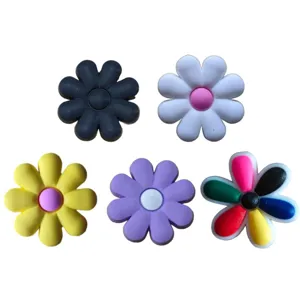 Close-up detail of colorful eight-petal PVC shoe charms, cute cartoon decoration for clogs.