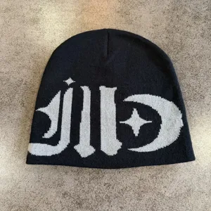 Black knit beanie hat featuring bold gothic style typography and contrast star moon pattern.