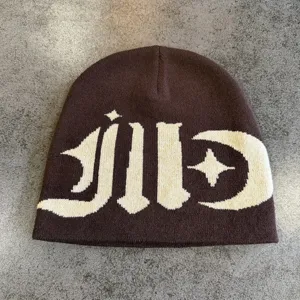 Knitted beanie hat with contrast gothic graphic and star moon design, warm winter streetwear.