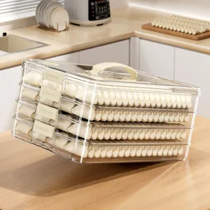 Clear multi-layer dumpling storage box for refrigerator freezer with handle and food containers.