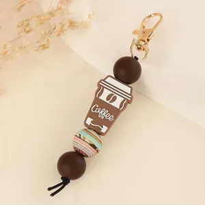 Silicone bead keychain with cute coffee cup pendant, detailed close-up shot of DIY bag charm.