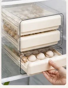 Transparent refrigerator egg storage box with multi tier drawer design for kitchen.