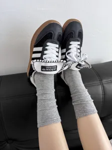 Close-up detail shot of casual solid grey cotton slouch socks paired with sneakers for daily wear.