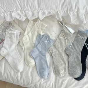 Detailed view of ballet style mesh socks with sweet bows and delicate lace ruffles.