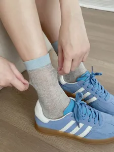 Detailed view of women's breathable mesh mid-tube socks in grey and blue for summer.