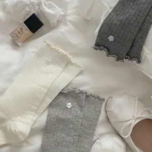 Korean style cute ruffled crew socks for women featuring delicate flower button details.