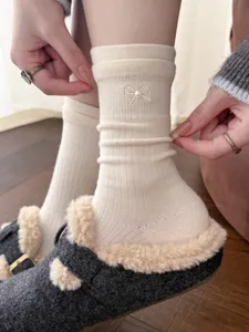 Beige knit mid-tube socks for women featuring elegant pearl bow embroidery and cozy style.