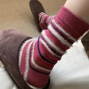 Retro contrast striped women's cozy fuzzy winter warm mid-tube slouch socks fashion detail view.