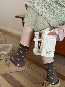 Detail view of stylish Korean style bow cable knit socks and vintage floral mid-calf socks.