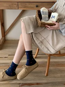 Cute floral mid-tube socks with delicate lace trim and sweet bow detail, cozy aesthetic style.