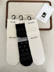 Detail shot of thin sheer ruffle stack socks with lace pattern, elegant sheer hosiery detail.