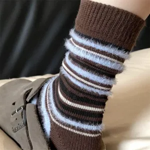 Close-up detail of retro mocha color-blocked striped fuzzy winter socks with soft plush texture.