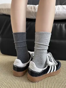 Detailed view of long stacked socks in grey, showcasing the soft texture and fit.