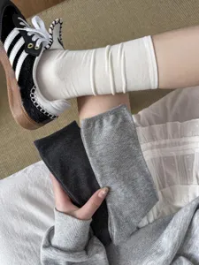 Detailed close-up of versatile slouch cotton socks in black, white, and grey colors.