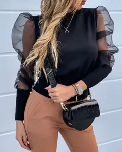 Close up detail of women mesh puff sleeve top, stylish black long sleeve shirt outfit.