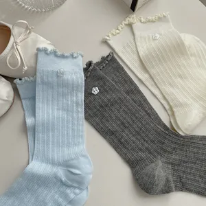 Korean style lettuce edge mid-calf socks with cute flower buttons, comfortable cotton daily wear.