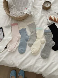 Women's mid-tube socks detail view, featuring comfortable ribbed cotton material and chic colors.