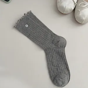 Grey ribbed mid-calf socks for women featuring cute lettuce edge and floral button detail.