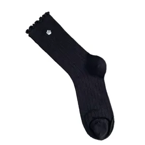 Black ribbed mid-calf socks for women with cute flower button and lettuce trim.