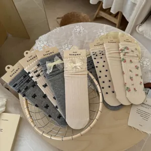 Detailed view of women's lace bow mid-calf socks, stylish sweet style thin summer hosiery.