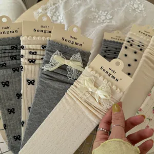 Close-up detail of women's lace bow mid-calf socks in soft balletcore style display.