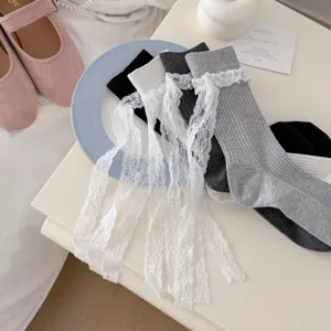 Detailed view of sweet lolita style ribbon lace ruffle ribbed crew socks for women.