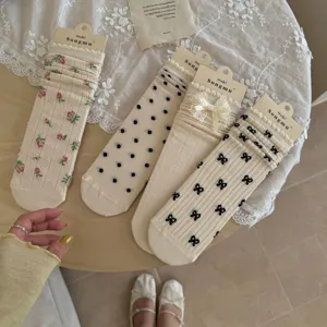 Detail view of sweet bow and floral mid-calf socks, perfect summer JK style thin hosiery.