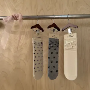Detailed view of women summer sheer mid-calf socks featuring cute bows and polka dots design.