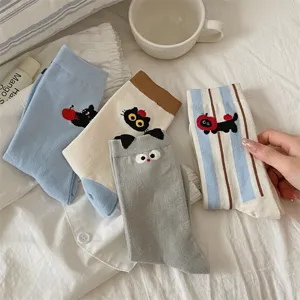Detailed view of cute cat and apple embroidered mid-tube cotton socks in various colors.