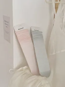 Comfortable casual solid color long socks for women, soft and breathable daily wear.