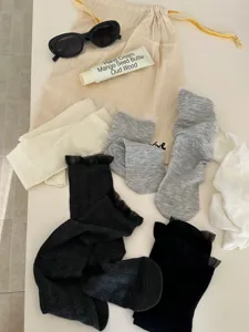 Detailed view of solid color lace trim hollow socks, breathable spring and summer casual hosiery.