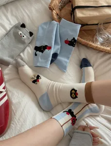 Detailed shot of cute cat and apple cartoon mid-tube socks featuring vertical stripe design.