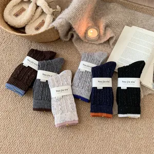 Detailed view of thick warm wool socks, speckled yarn winter cozy mid-tube socks in cozy colors.