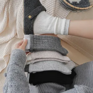 Cozy thick wool ribbed crew socks detail shot showing soft texture and multiple warm colors.