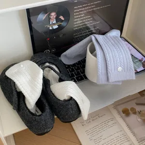 Cable knit mid-tube socks with delicate shell button, cozy daily wear material detail view.