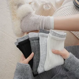 Detailed view of thick wool cashmere winter stack socks in multiple colors with cozy home setting.