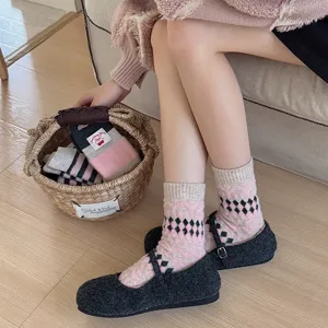 Cozy fleece-lined women mid-tube socks with argyle pattern and sweet bow detail for home.